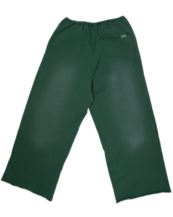 Dark green trousers shown from the back, featuring an elastic waistband and a single back pocket.