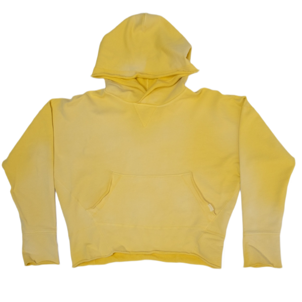 A cropped butter yellow hoodie sweatshirt with a front kangaroo pocket, laid flat against a white background.