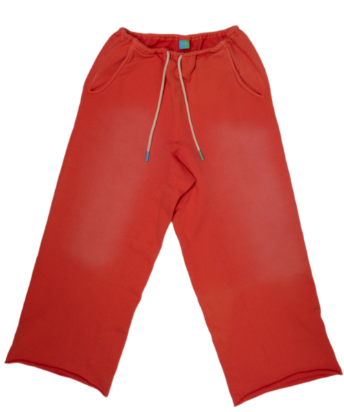 Red sweatpants with a drawstring waist and side pockets, laid flat on a white background.